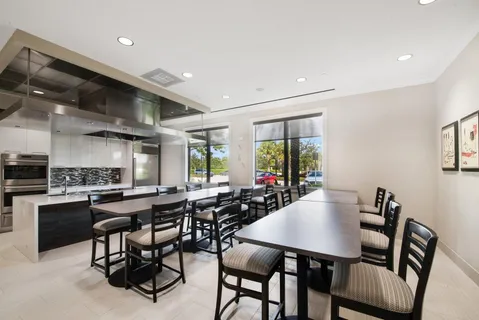 a view of a dining room with furniture and a large window