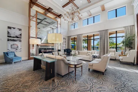 a living room with fireplace furniture and a large window