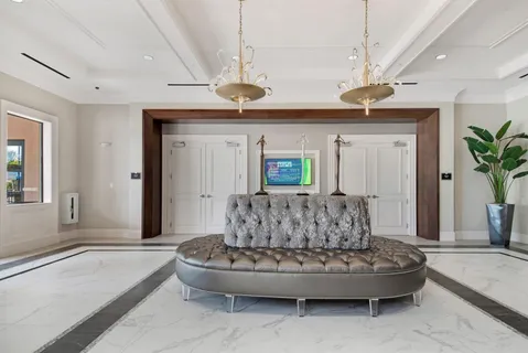 a living room with furniture and a chandelier