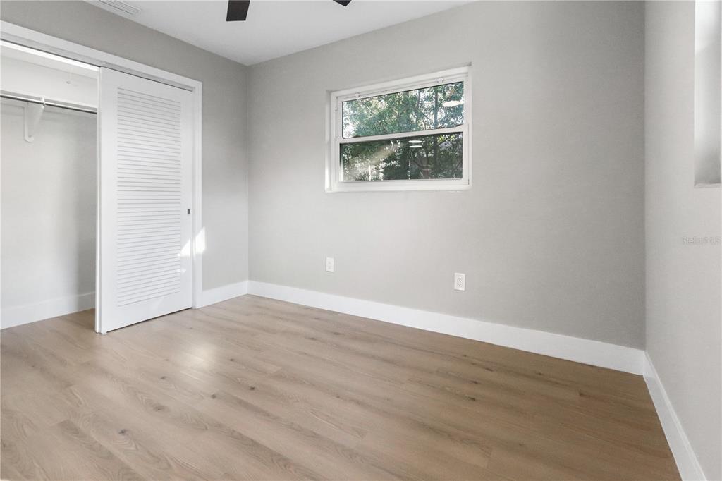 772 Palmer Road Belleair Bluffs, FL 33770 - Photo 12 of 26 a view of an empty room with wooden floor and a window