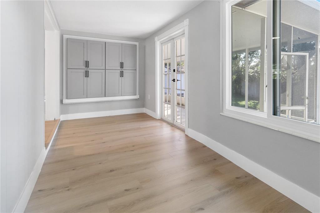 772 Palmer Road Belleair Bluffs, FL 33770 - Photo 13 of 26 an empty room with wooden floor and windows