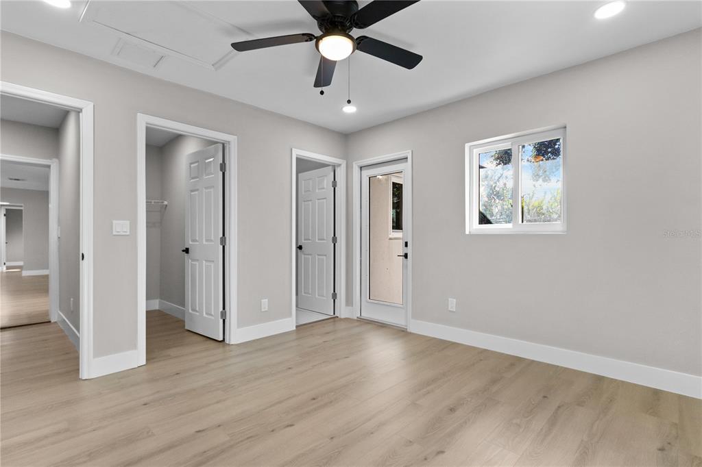 772 Palmer Road Belleair Bluffs, FL 33770 - Photo 15 of 26 an empty room with wooden floor and ceiling fan