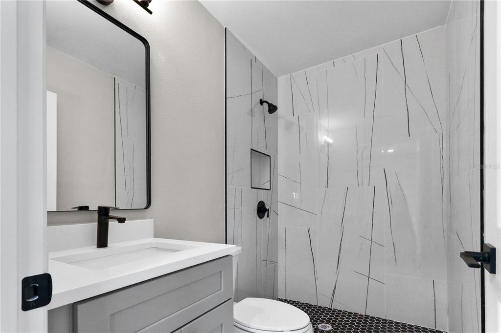 772 Palmer Road Belleair Bluffs, FL 33770 - Photo 16 of 26 a bathroom with a sink toilet and shower