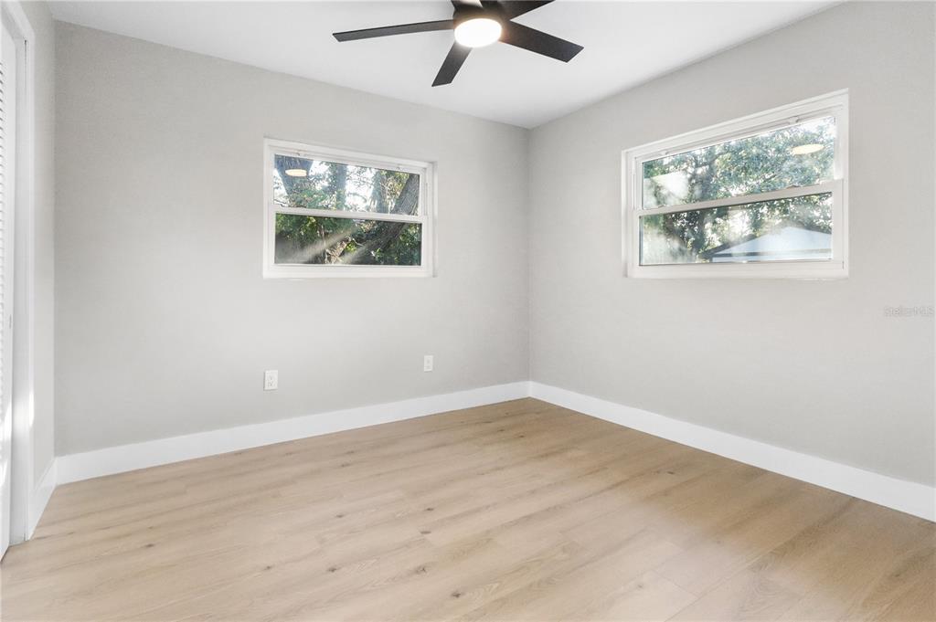 772 Palmer Road Belleair Bluffs, FL 33770 - Photo 10 of 26 wooden floor in an empty room with a window