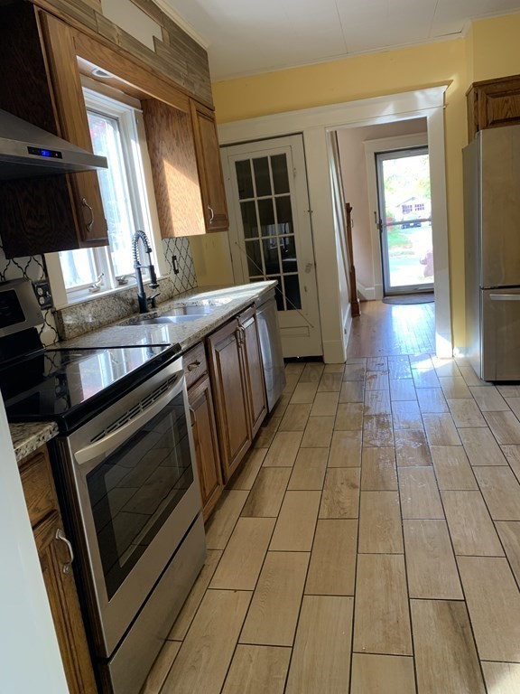 229 Fountain Street Springfield, MA 01108 - Photo 2 of 18 a kitchen with stainless steel appliances a stove a sink and a microwave