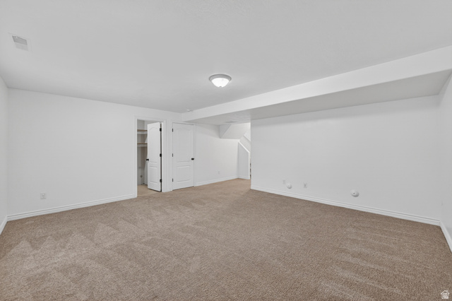 14771 Haddington Road Draper, UT 84020 - Photo 28 of 44 Spacious room featuring neutral carpeting, white walls, and a flush-mount ceiling light