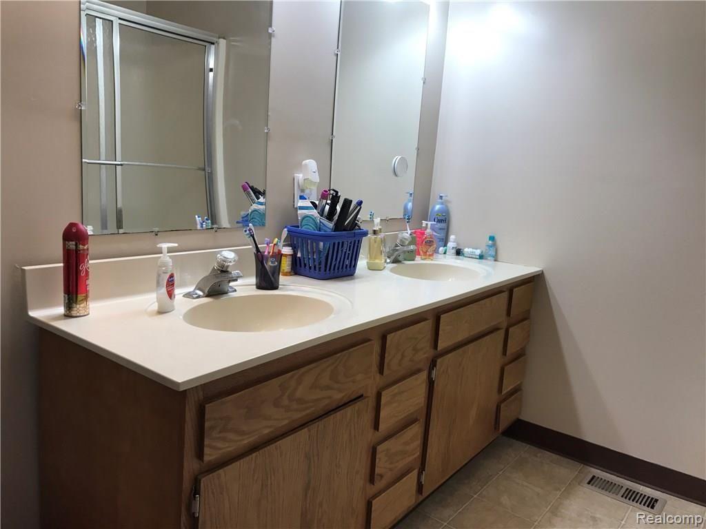 224 West Ridge Street Owosso, MI 48867 - Photo 8 of 23 Dual sinks in large bathroom.