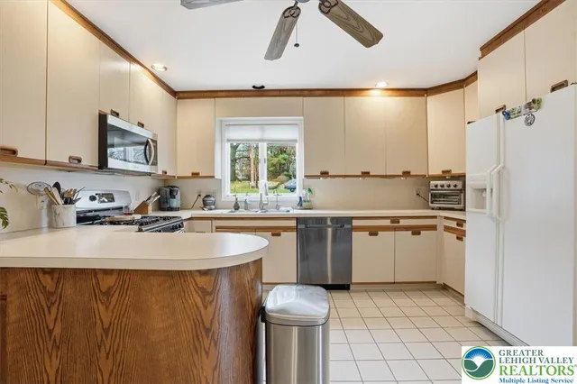 a view of staircase with lots of frames on wall and wooden floor