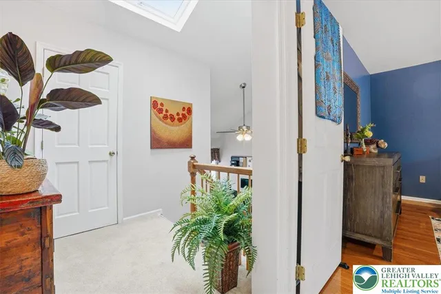 a bedroom with a bed mirror and a window