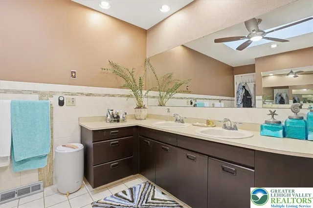 a view of a house with a small yard and wooden fence