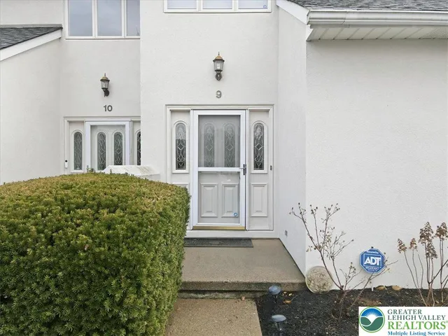 a living room with furniture a rug and a window