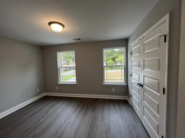 a view of room with window and hardwood floor