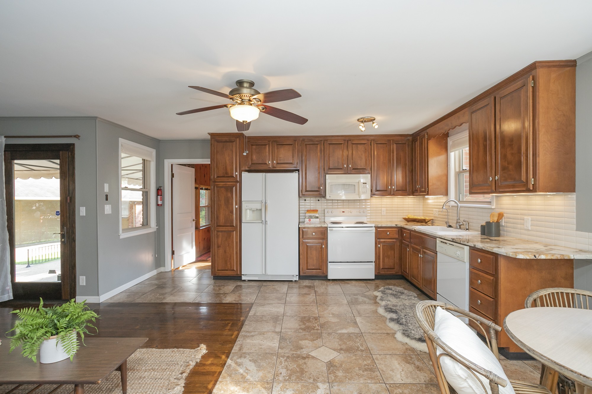 1018 Mitchell Road Nashville, TN 37206 - Photo 12 of 44 a kitchen with a refrigerator a stove top oven a sink dishwasher and wooden cabinets