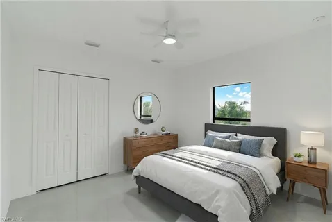 a bedroom with a bed and a mirror