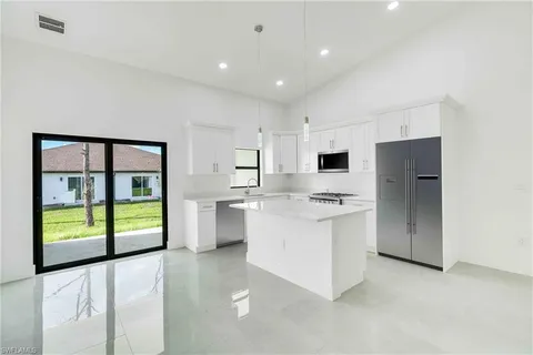 a kitchen with stainless steel appliances a refrigerator and a stove