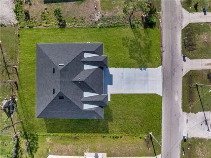 an aerial view of a house with a yard