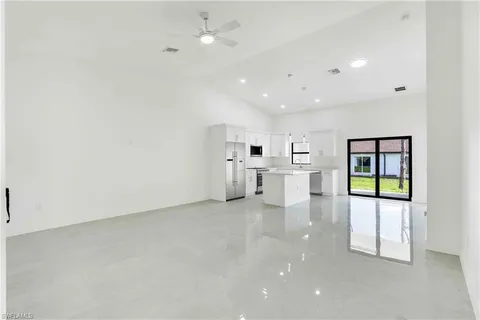 an empty room with windows and cabinet