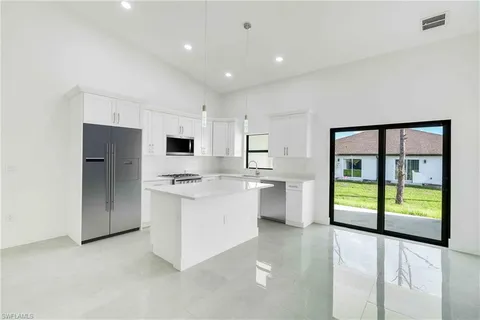 a kitchen with stainless steel appliances a refrigerator sink and stove