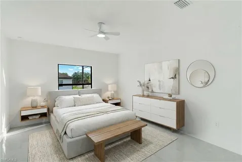 a bedroom with bed and a chandelier