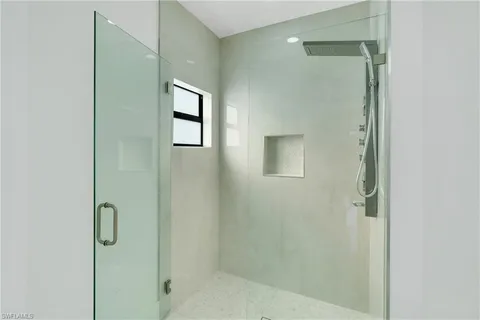 a bathroom with a glass shower door