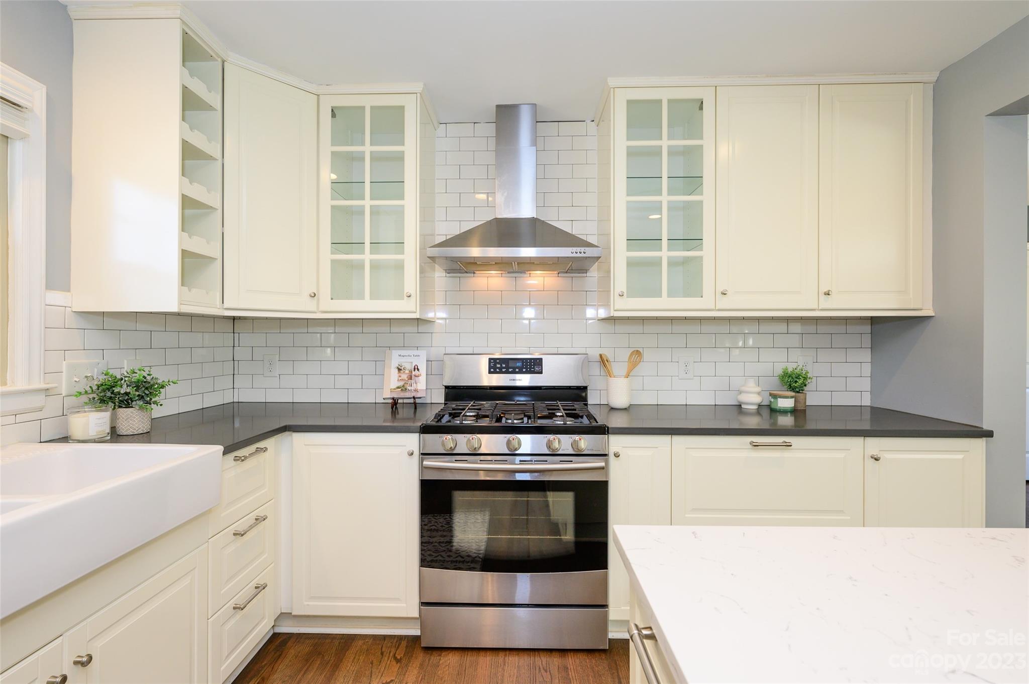 2901 Enfield Road Charlotte, NC 28205 - Photo 16 of 29 a kitchen with stainless steel appliances granite countertop a stove and white cabinets