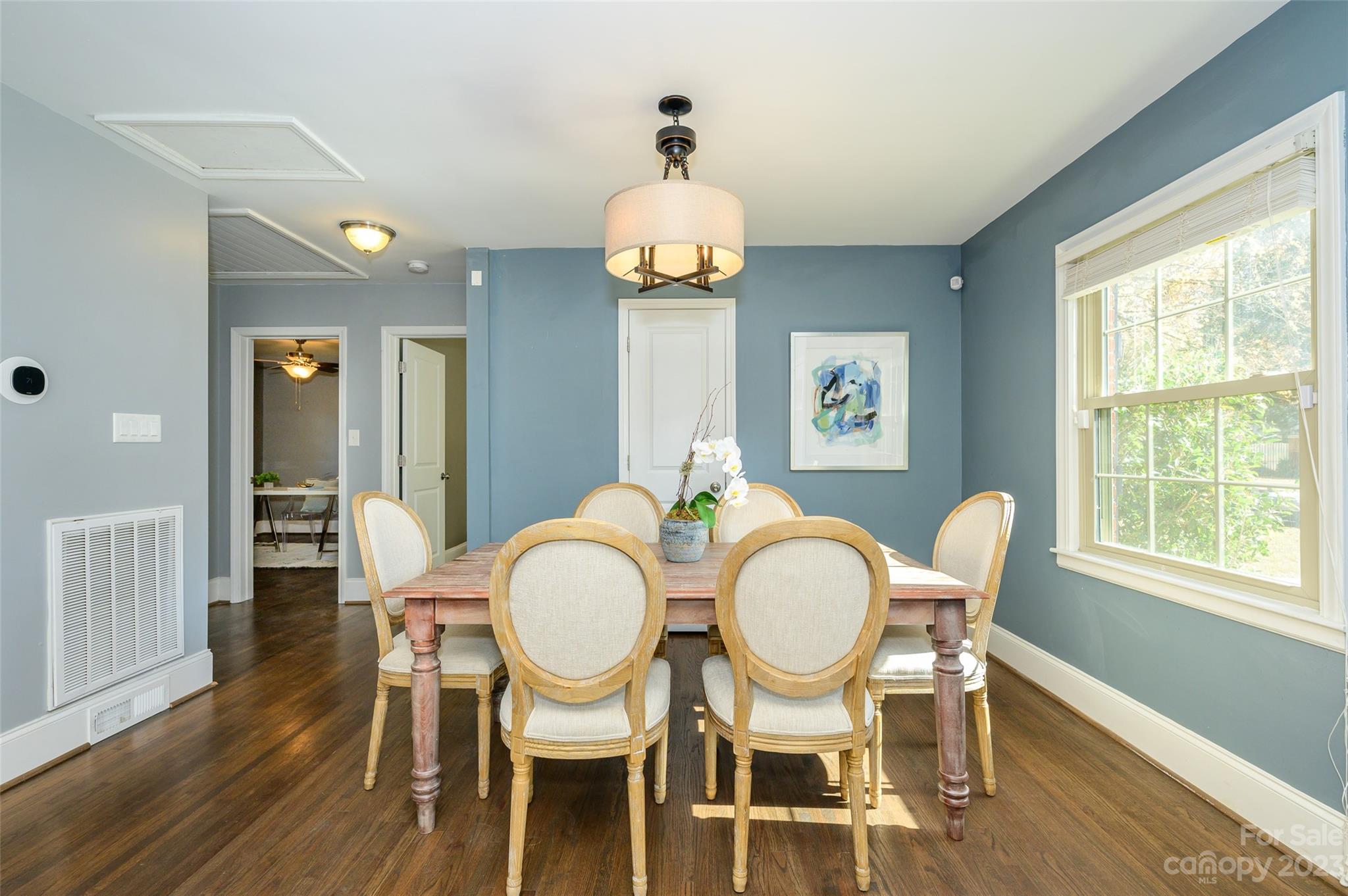 2901 Enfield Road Charlotte, NC 28205 - Photo 10 of 29 a dining room with chandelier and wooden floor