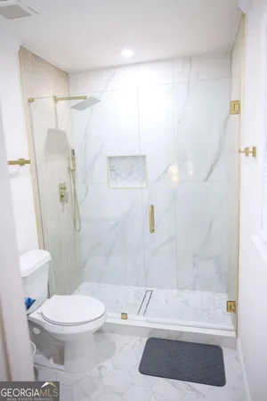 a bathroom with a sink a mirror and a toilet