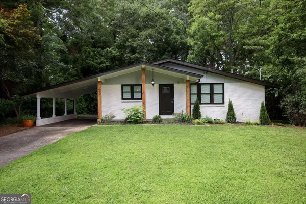 a front view of house with yard and green space
