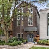 a front view of a building with a garden