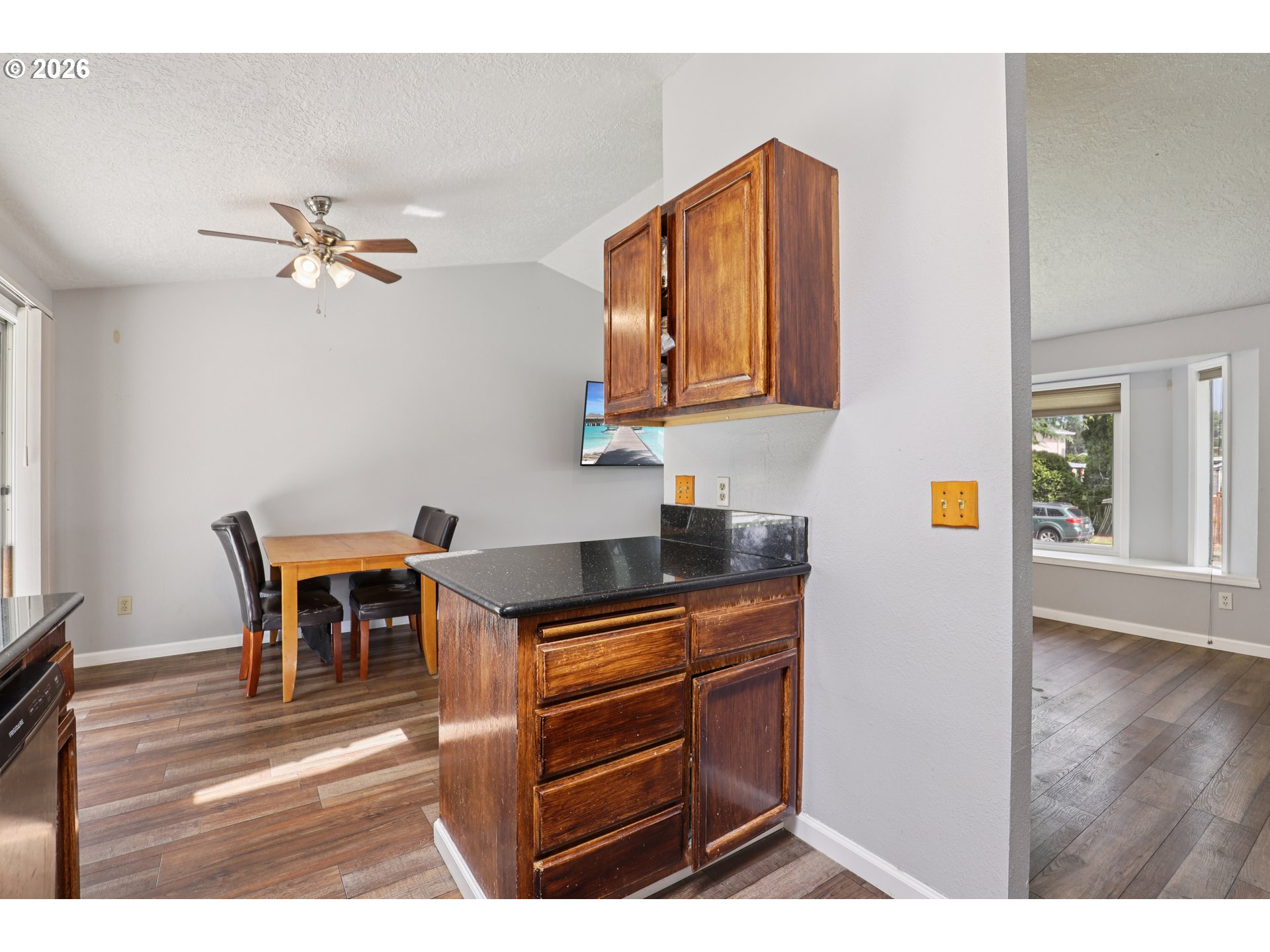 691 Southwest Linneman Court Gresham, OR 97030 - Photo 14 of 35 a kitchen view of a dining table chairs and chandelier