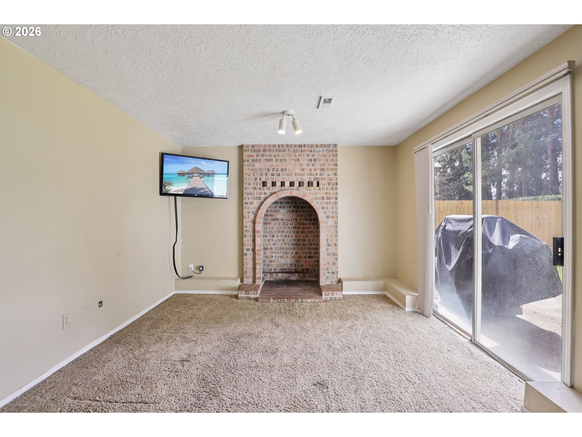 691 Southwest Linneman Court Gresham, OR 97030 - Photo 15 of 35 a view of an empty room with a fireplace and a window