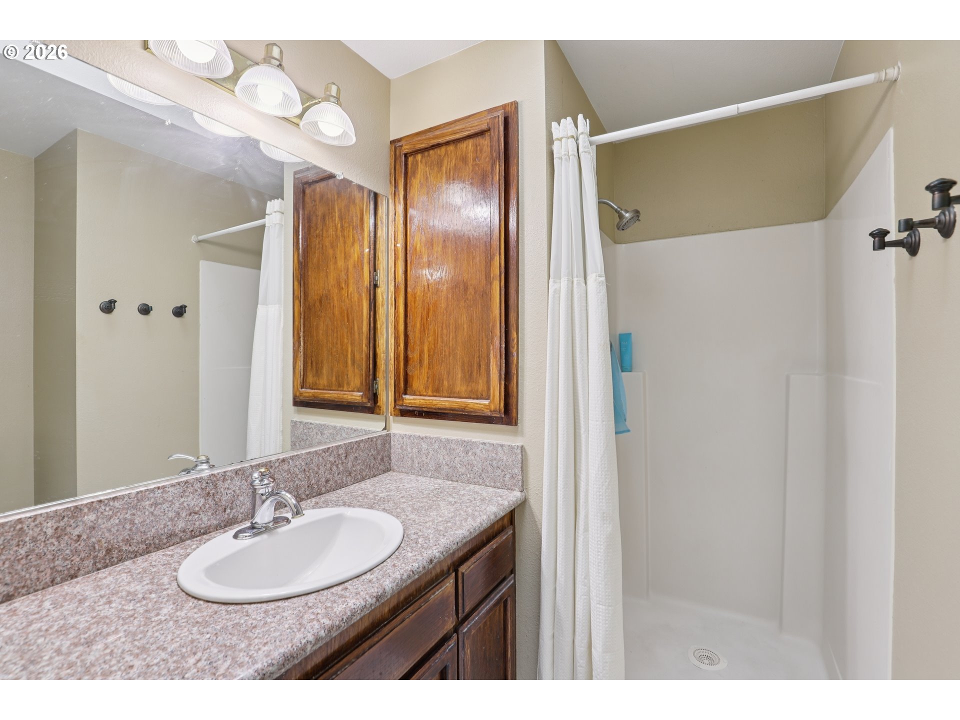 691 Southwest Linneman Court Gresham, OR 97030 - Photo 19 of 35 a bathroom with a granite countertop sink and a mirror