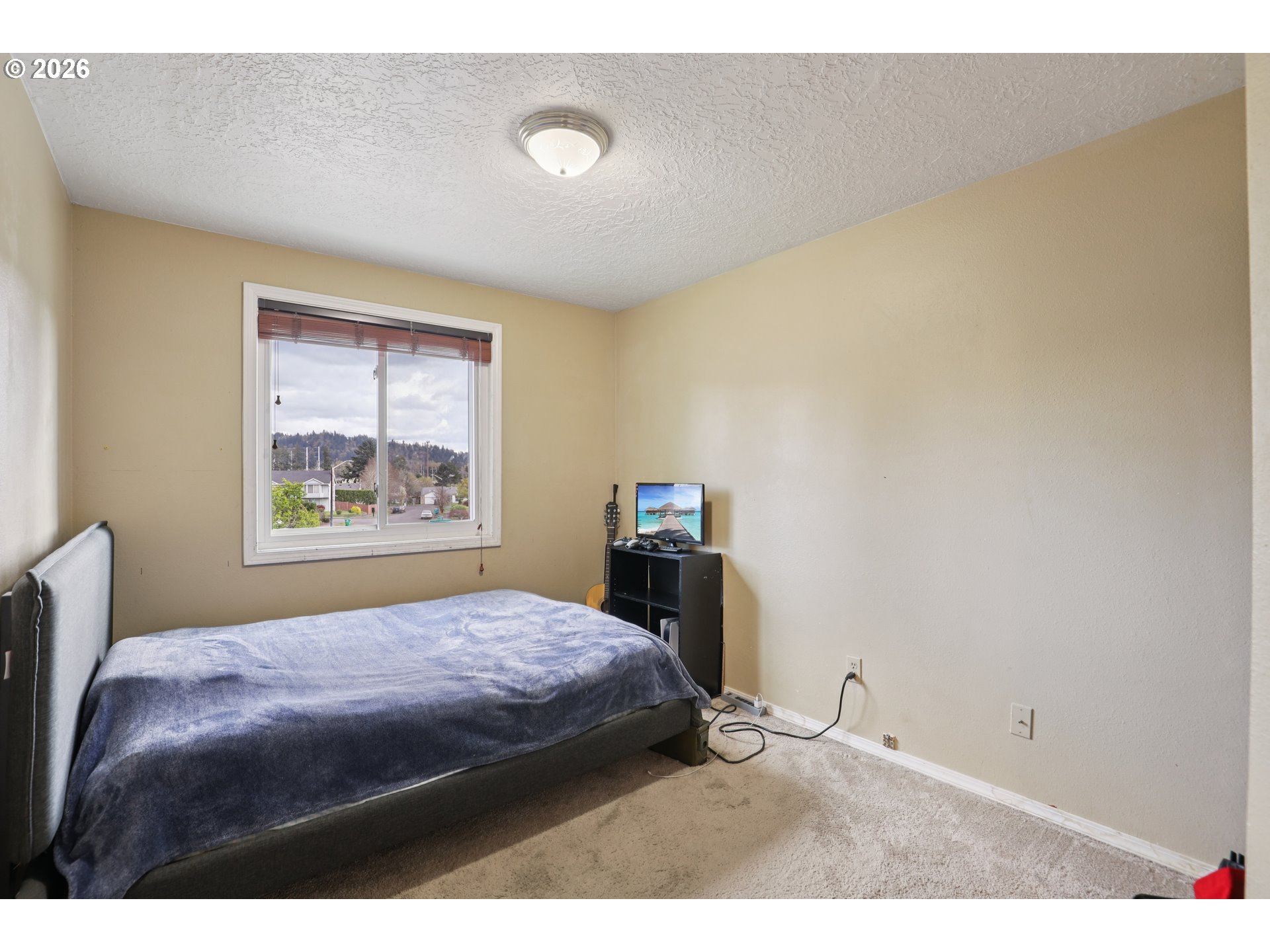 691 Southwest Linneman Court Gresham, OR 97030 - Photo 23 of 35 a bedroom with a bed and a window