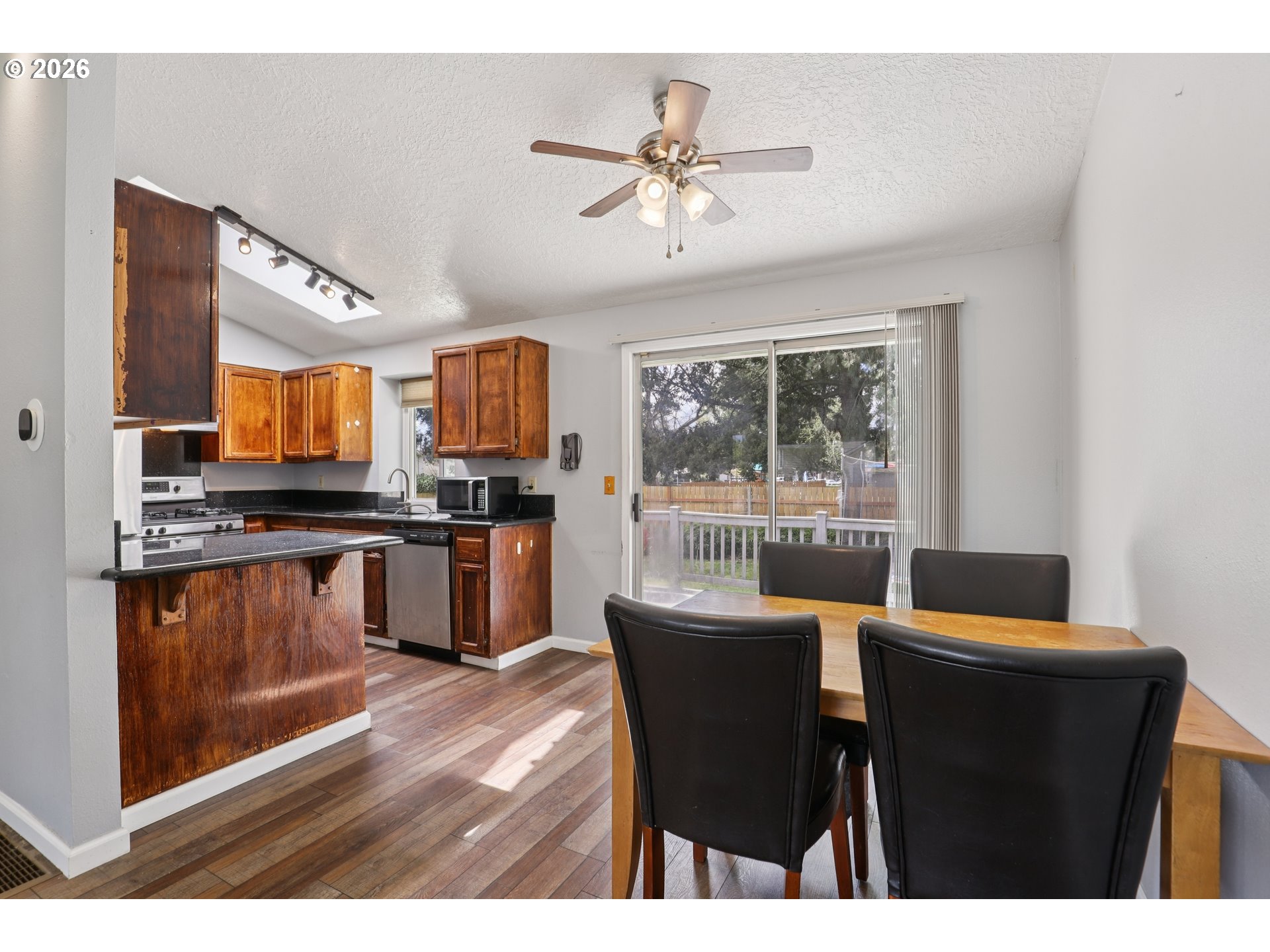 691 Southwest Linneman Court Gresham, OR 97030 - Photo 9 of 35 a living room with stainless steel appliances kitchen island granite countertop furniture and a view of kitchen