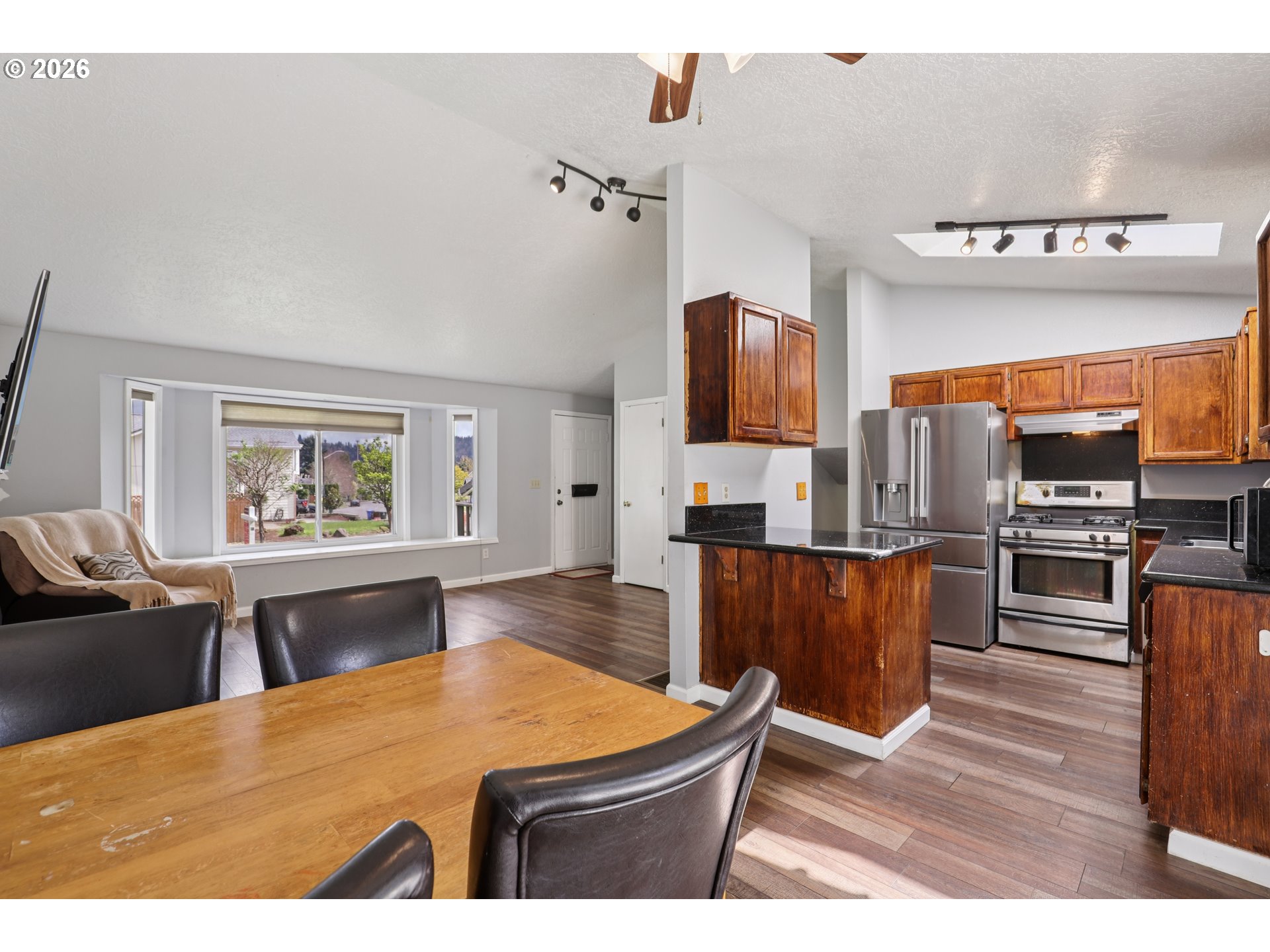 691 Southwest Linneman Court Gresham, OR 97030 - Photo 10 of 35 a living room with fireplace furniture and a wooden floor
