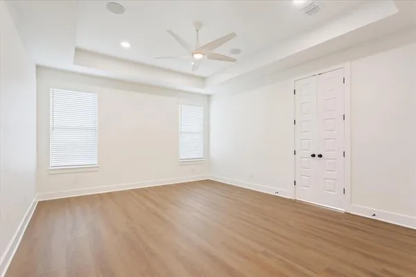 a view white cabinets with wooden floor