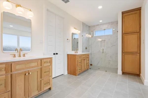 a spacious bathroom with a double vanity sink mirror and