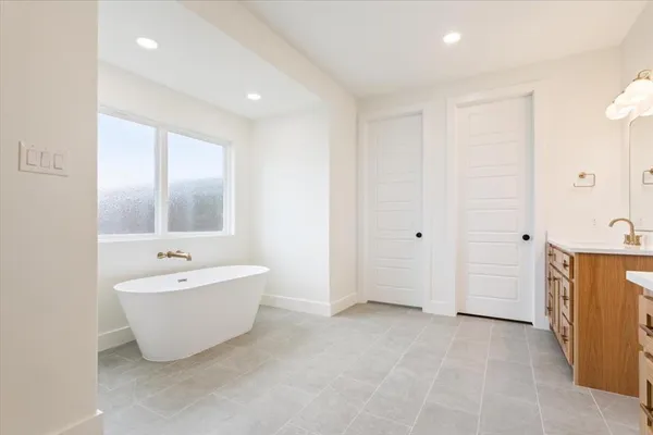 a bathroom with a sink a shower a mirror and a bathtub