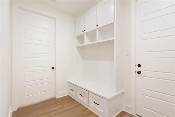 a kitchen with white cabinets and sink