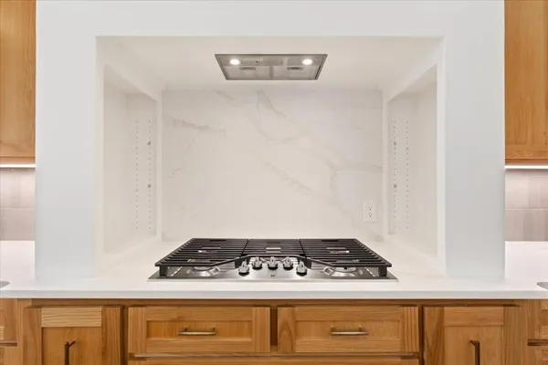 a kitchen with stainless steel appliances granite countertop a refrigerator a sink and a stove