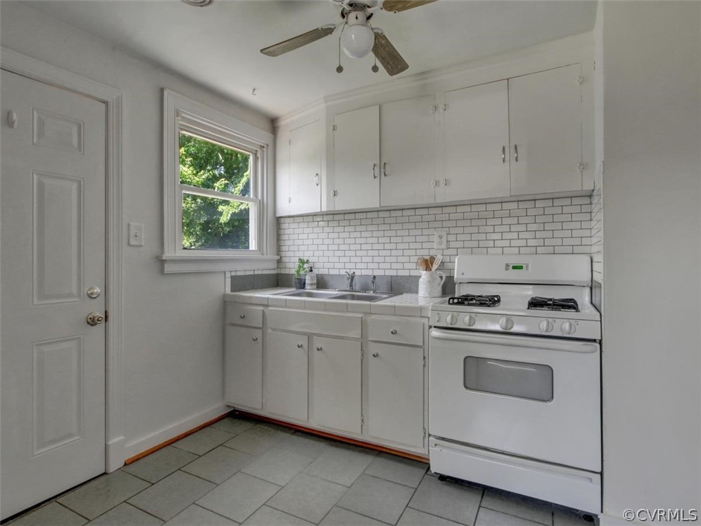 514 Riverview Road Colonial Heights, VA 23834 - Photo 3 of 17 a kitchen with a stove sink and cabinets