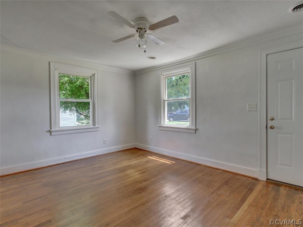 514 Riverview Road Colonial Heights, VA 23834 - Photo 5 of 17 a view of an empty room with wooden floor and a window
