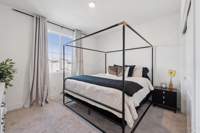 a bedroom with a bed and window