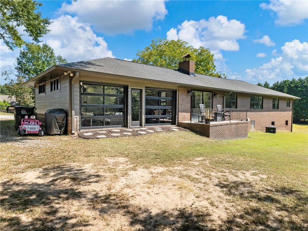 3125 Bart Johnson Road Buford, GA 30519 - Photo 37 of 50 a front view of house with outdoor seating and barbeque oven