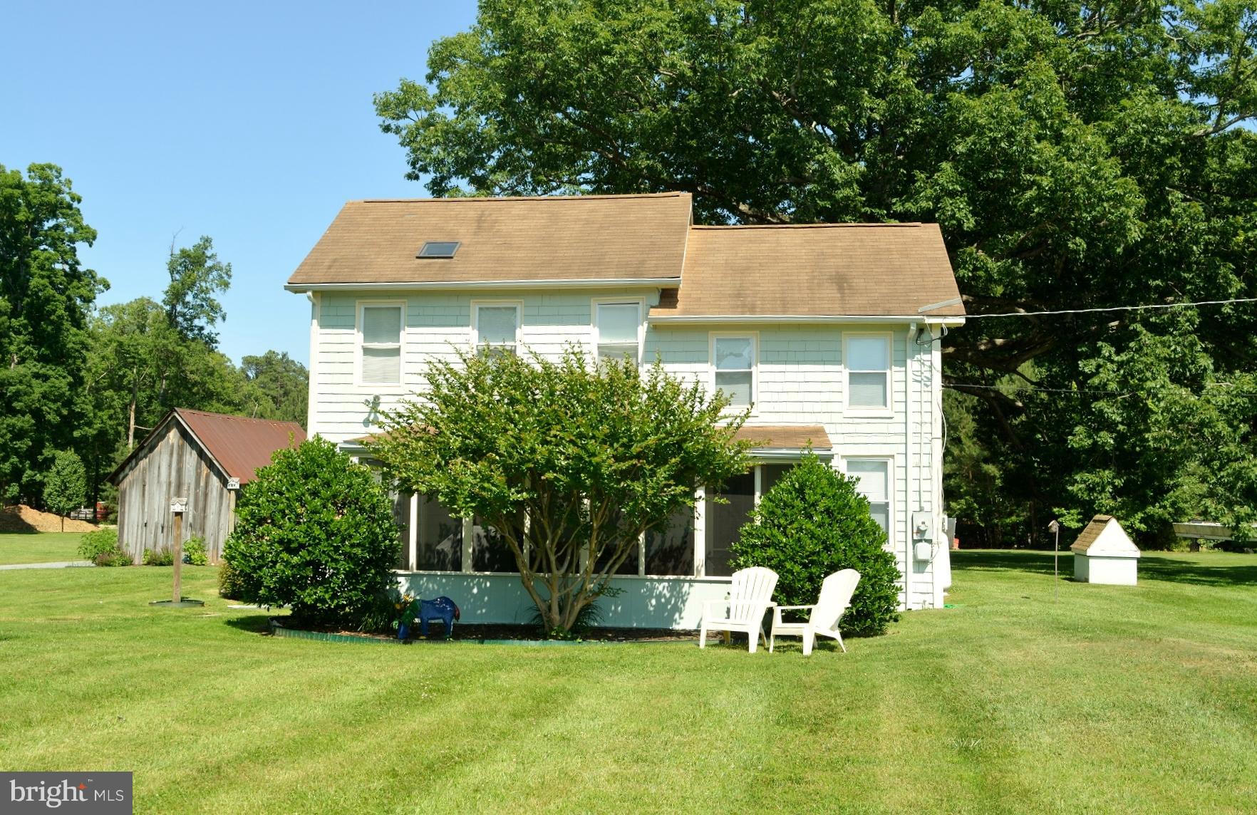 7967 Quaker Neck Road Bozman, MD 21612 - Photo 20 of 21 a backyard of a house with plants and large tree