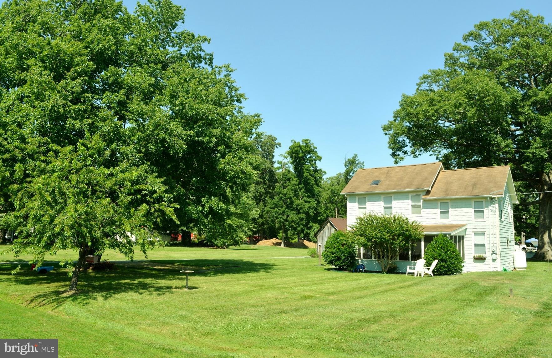 7967 Quaker Neck Road Bozman, MD 21612 - Photo 21 of 21 a view of a big house with a big yard and large trees