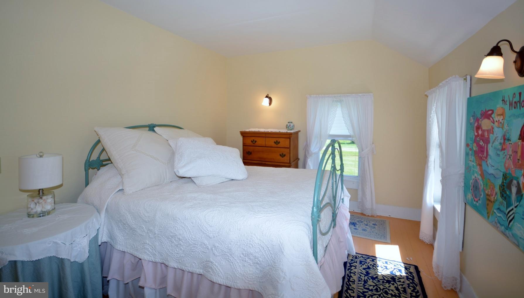 7967 Quaker Neck Road Bozman, MD 21612 - Photo 8 of 21 a bedroom with a bed and a flat screen tv