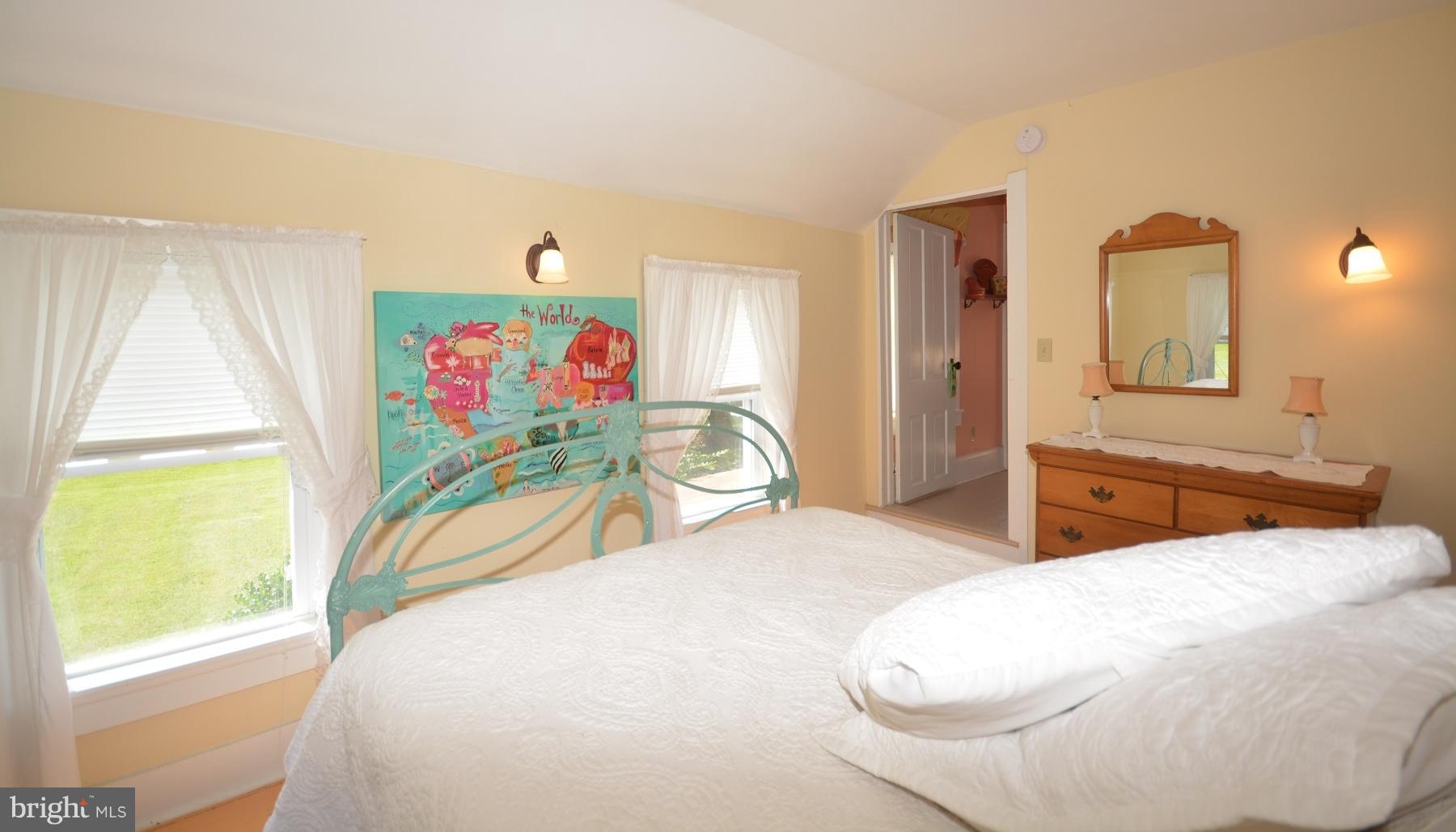 7967 Quaker Neck Road Bozman, MD 21612 - Photo 9 of 21 a bedroom with two beds and a large window