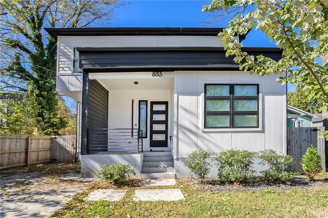 a front view of a house with garden