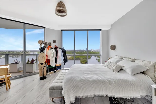 a bedroom with bed and a chandelier